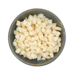 Diced potatoes in old bowl on white background