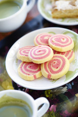 many pink cookies and green tea in coffee shop
