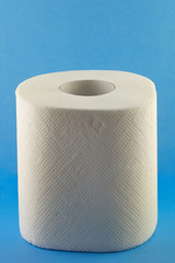 Toilet paper on blue background - the hygiene concept
