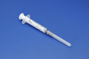Plastic disposable syringe with a needle in the protective cap