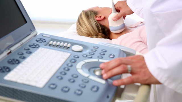 Doctor taking a sonogram of patients neck