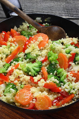 Millet fried with carrots, broccoli, paprika and onion