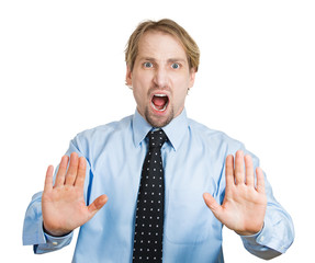 Angry, serious business man asking to stop, hands up