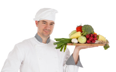Young chef holding fresh vegetable
