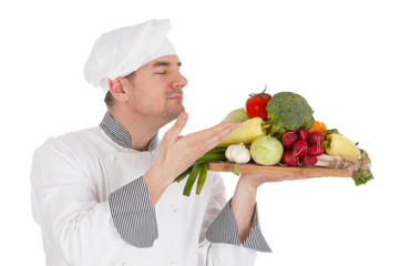 Young chef smelling aroma of vegetable