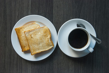 Coffee and  toast on wooden table