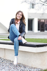 Student sitting on the bench near University