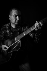 Obraz premium Guitar Hero - Man Playing Old Acoustic Guitar 3