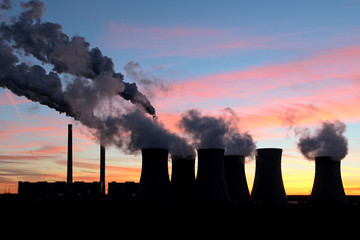 smoke from coal power plant under sunset sky