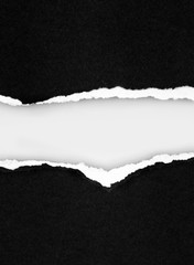 Torn black paper on white background