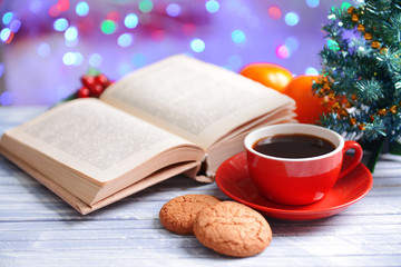 Composition of book with cup of coffee and Christmas