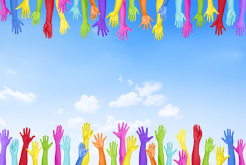 Colorful Hands Raised with Blue Sky
