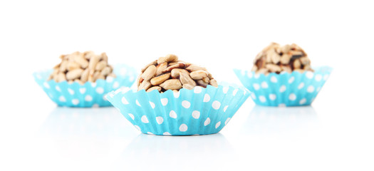 Chocolate candies with sunflower seeds, isolated on white