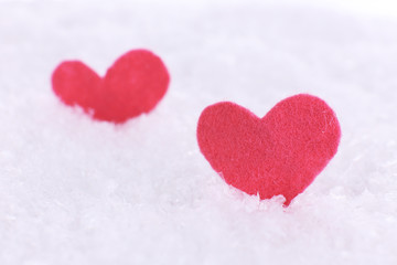 Fototapeta premium Little felt hearts on snowy background