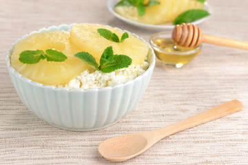 Bowl of tasty cottage cheese with pineapple, close up