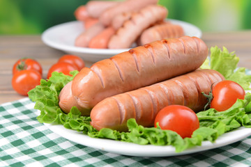 Grilled sausage on plate on table close-up
