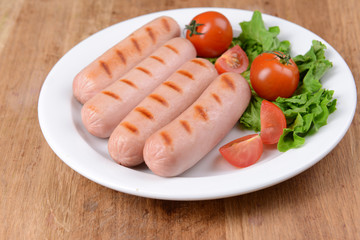 Grilled sausage on plate on table close-up