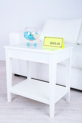 New white furniture with price on light background