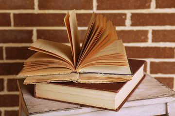 Books on wooden ladder on  color wall background