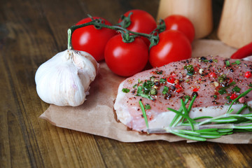 Raw meat steak with spices  herbs, on wooden background