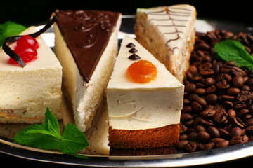 Assortment of pieces of cake, on dark background © Africa Studio