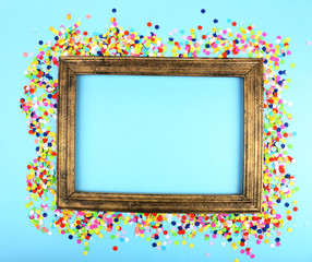 Photoframe with confetti on blue background