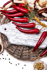 Different spices with blank cutting board, close up