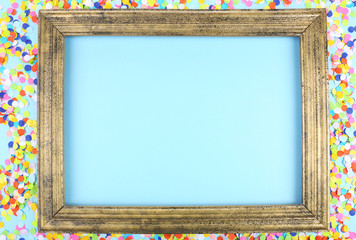 Photoframe with confetti on blue background