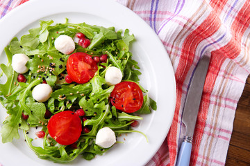 Green salad made with  arugula, tomatoes, cheese mozzarella