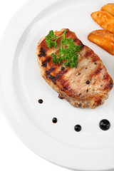 Grilled steak and fried potato pieces isolated on white