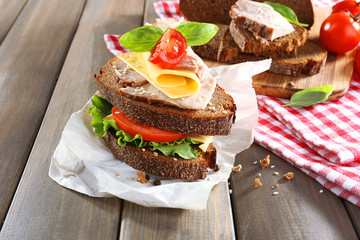 Delicious sandwiches with meet on table close-up