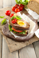Delicious sandwiches with meet on table close-up