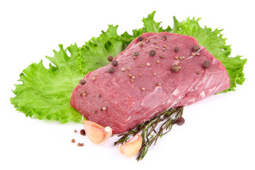 Raw beef meat with lettuce and spices isolated on white