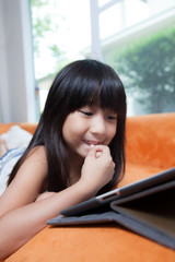 Girl playing with tablet.