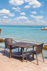 Table chair beside sea