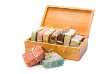 Handmade soaps in wooden box isolated on white background