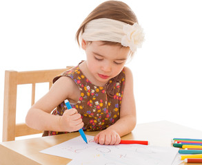 little girl with paints at the table.