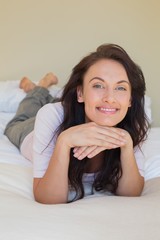 Obraz na płótnie Canvas Confident woman smiling while in bed