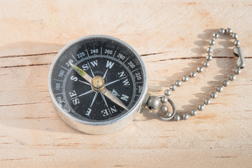 Fototapeta na wymiar Compass on wooden background