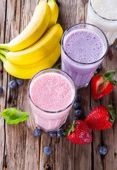 Fresh fruits milk shake on wood