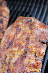 Spareribs on grill with dip and toasted baguette