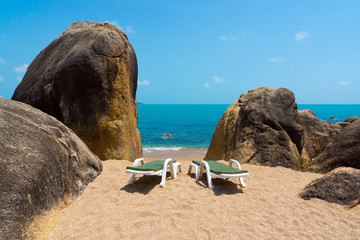 Two lounge chairs on the beach