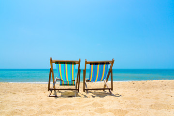 Two lounge chairs on the beach