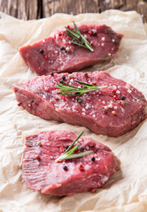 Raw beef steak on wooden table