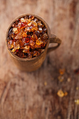 Gum arabic, also known as acacia gum - in wooden mug