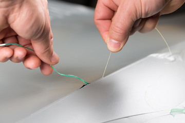 Car wrapper using knifeless wire tape to cut vinyl film