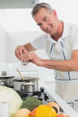 Side view portrait of a man preparing food in kitchen