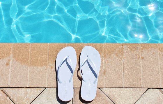 Poolside swimming pool holiday vacation scenic flip flops thongs stock, photo, photograph, image, picture, 