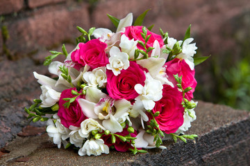Bouquet of flowers of white and red colors of orchids and roses