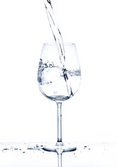 Glass with the stream of dinking water
